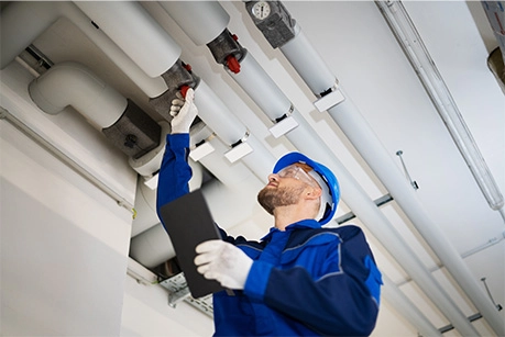 PVC Water Pipe Inspection By Construction Worker