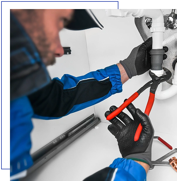 Plumber working in kitchen, Repair man service, repairing leaking water from sinks with red wrench