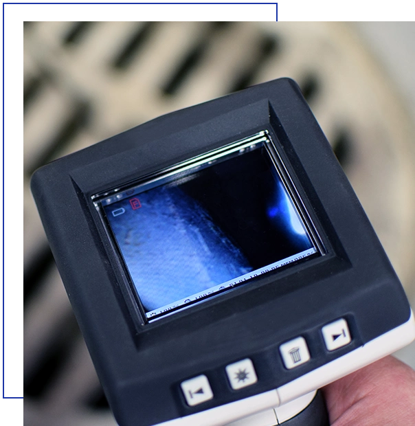 Checking sewer manhole with borescope inspection camera.