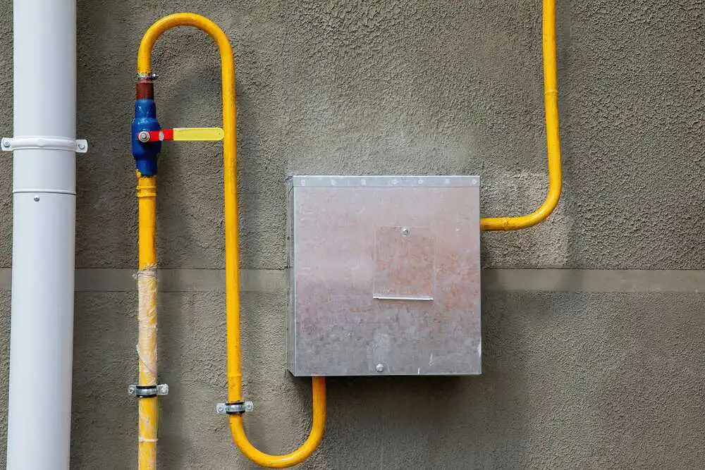 Gas distribution box with pipes on the wall of the house.